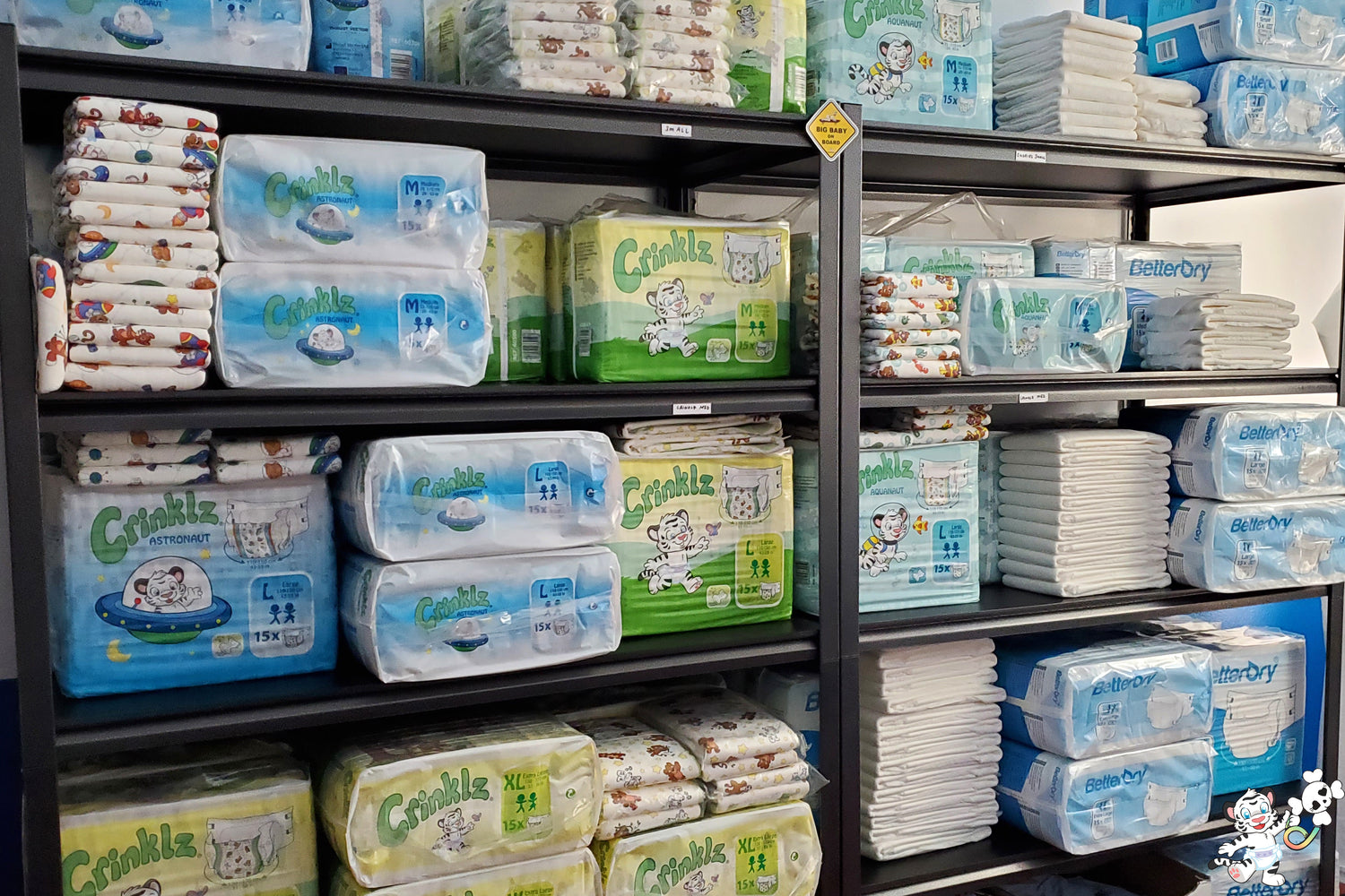 Stacks of Crinklz adult diapers. Shown are Astronaut, Original, and Aquanaut prints. Also shown are BetterDry adult diapers.