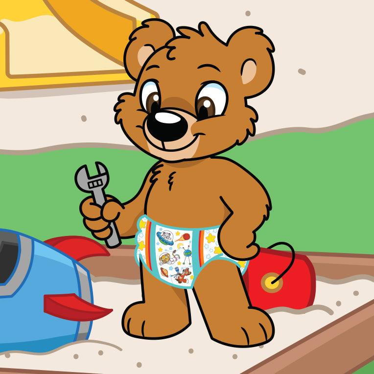Theo the bear is in his sandbox wearing Crinklz Astronaut print diapers. He's holding his wrench because he's fixing his toy rocket ship.